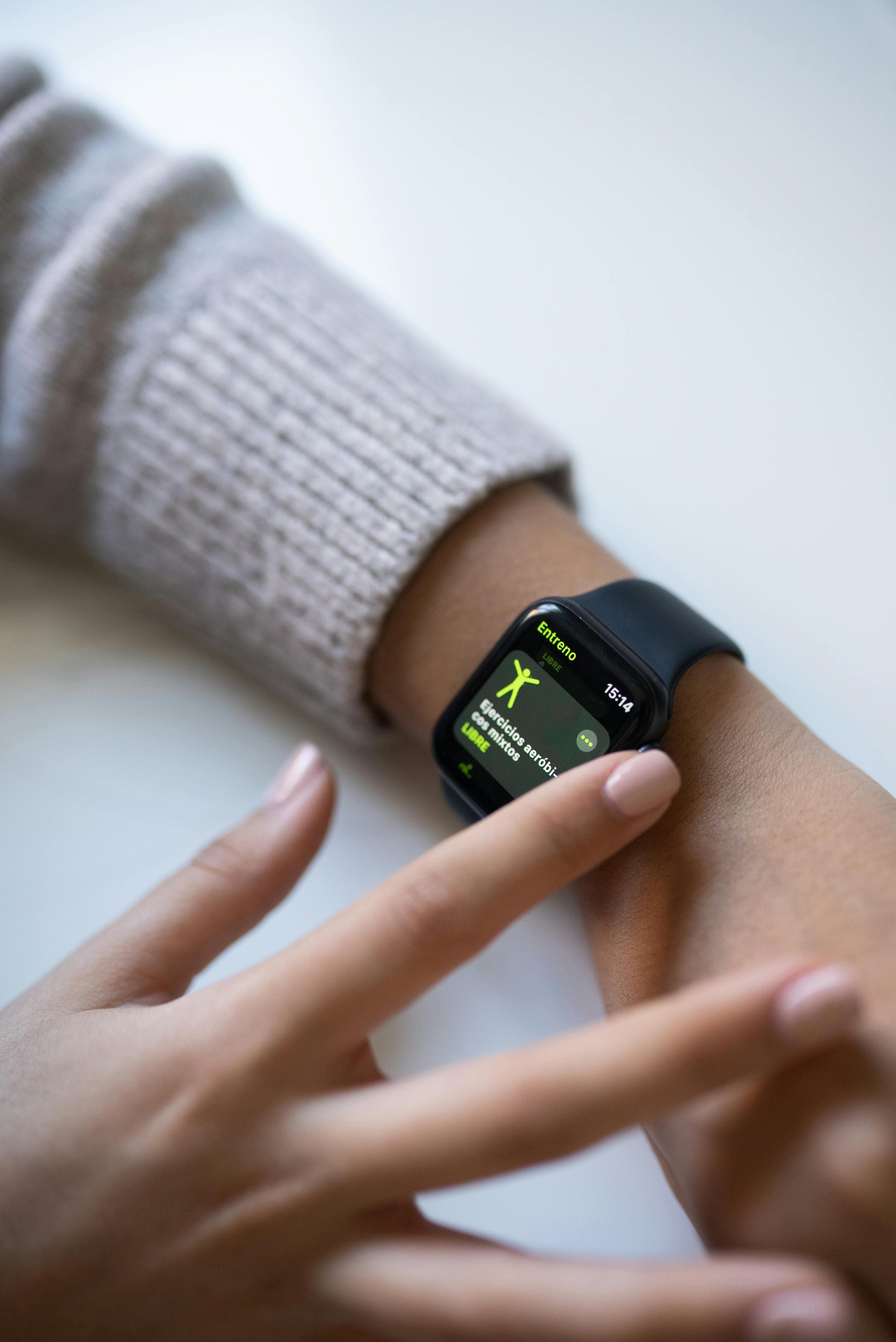 Athlete reviewing smartwatch fitness metrics after training