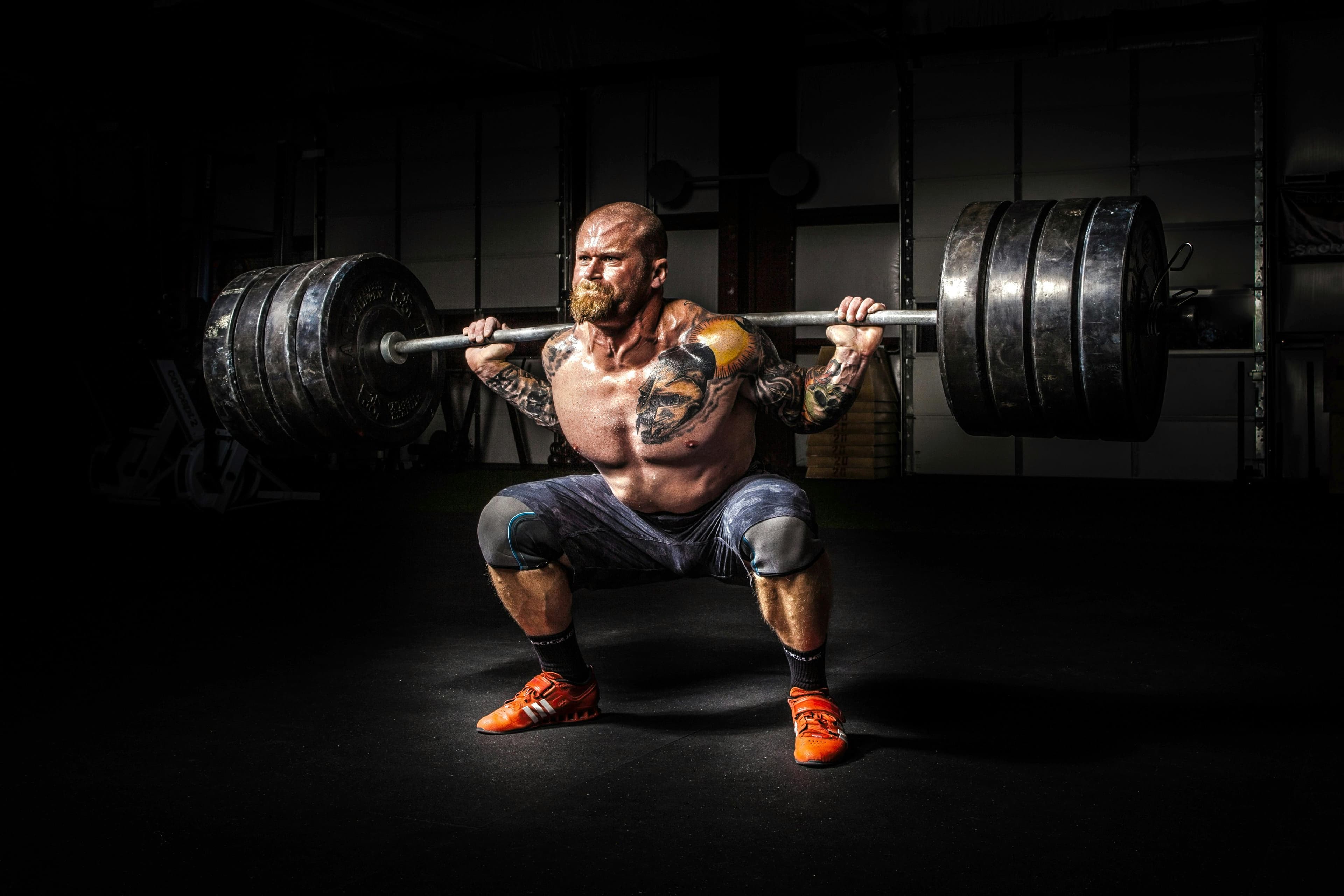 Powerlifter performing a heavy back squat in the gym