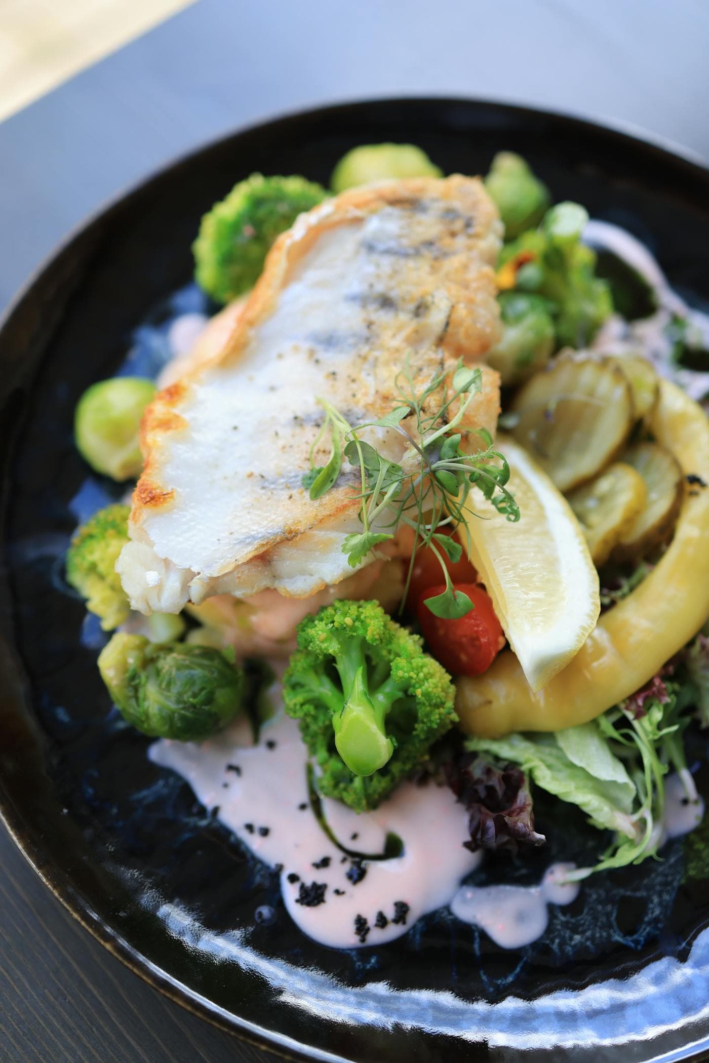 Fish and green vegetables on a plate for omega-3 and mineral intake