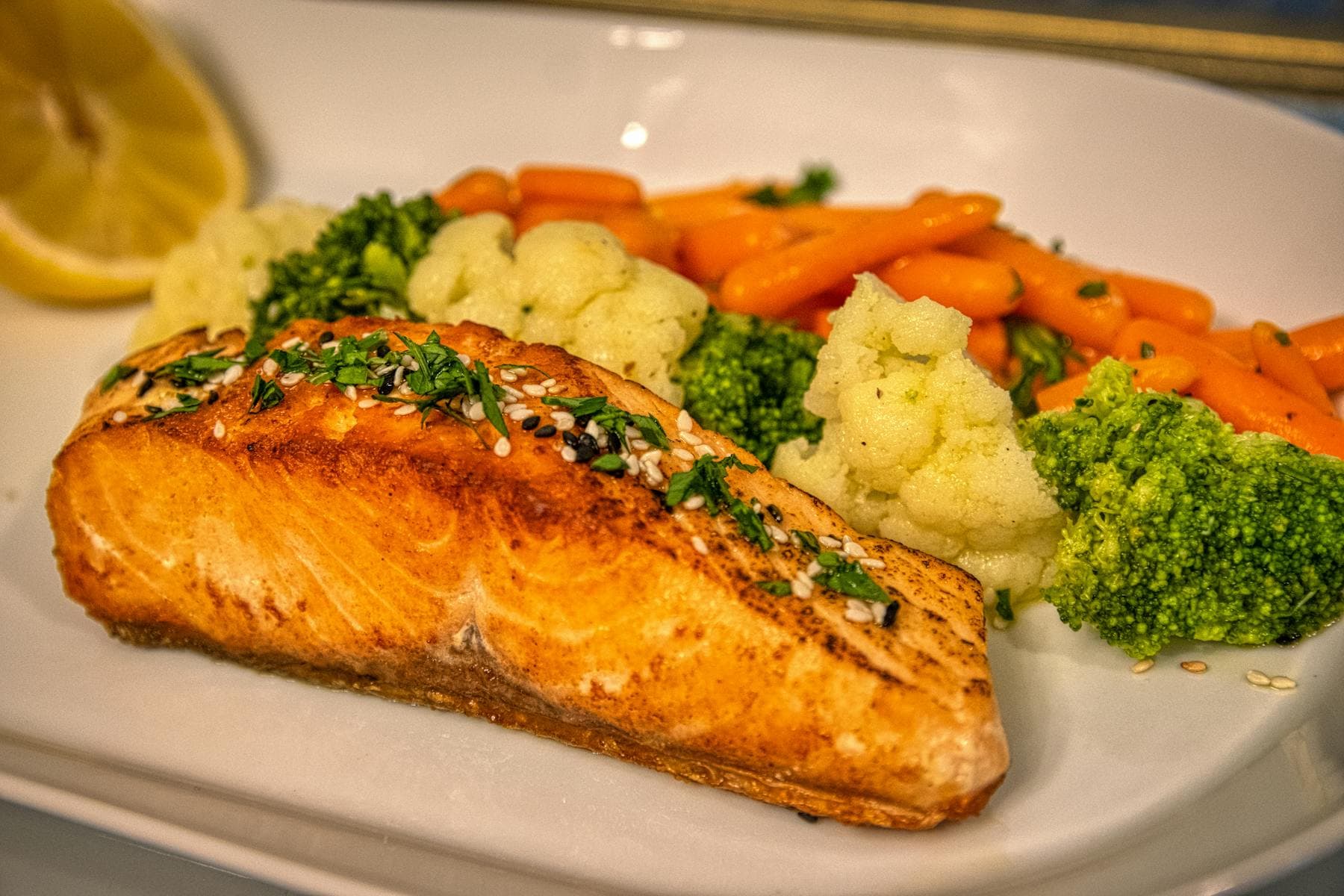 Salmon with broccoli and carrots plated as a micronutrient-rich performance meal