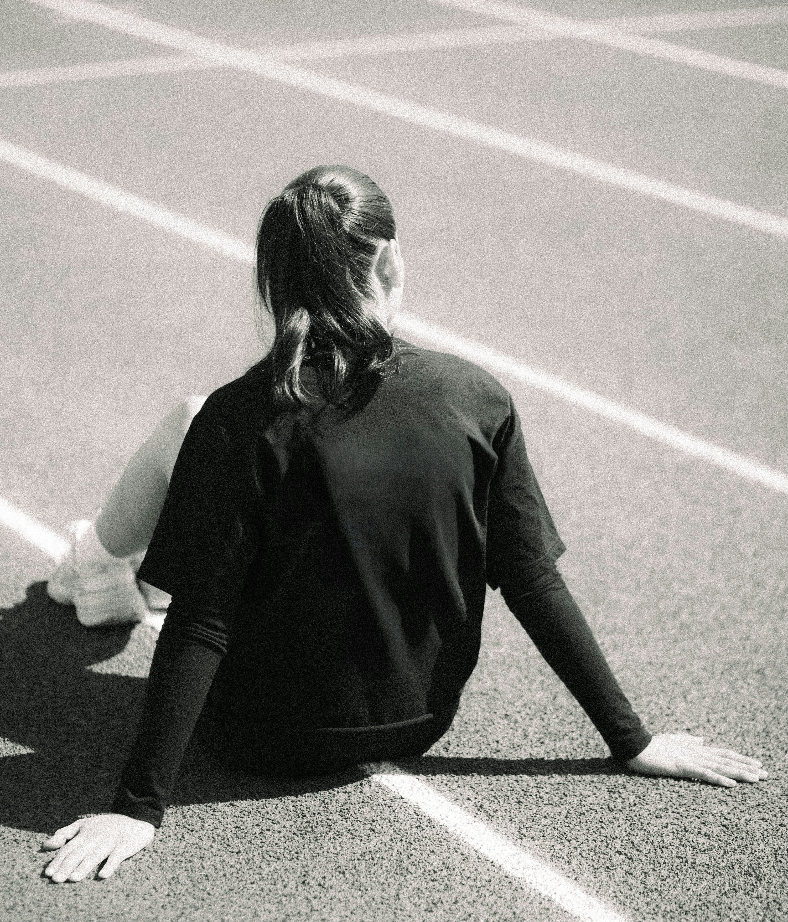 Athlete resting on a running track after training