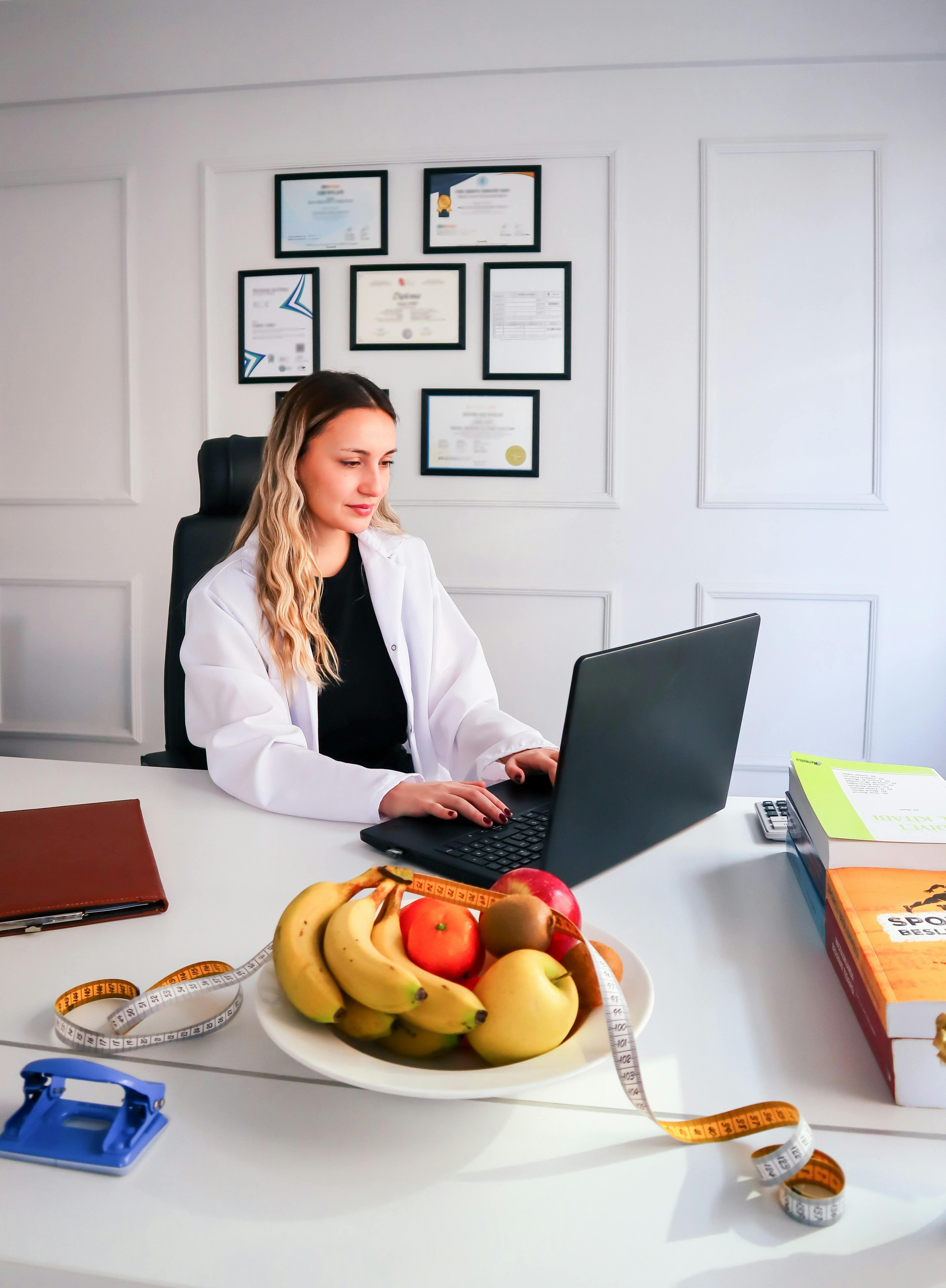 Nutrition professional using a laptop with diet-planning tools