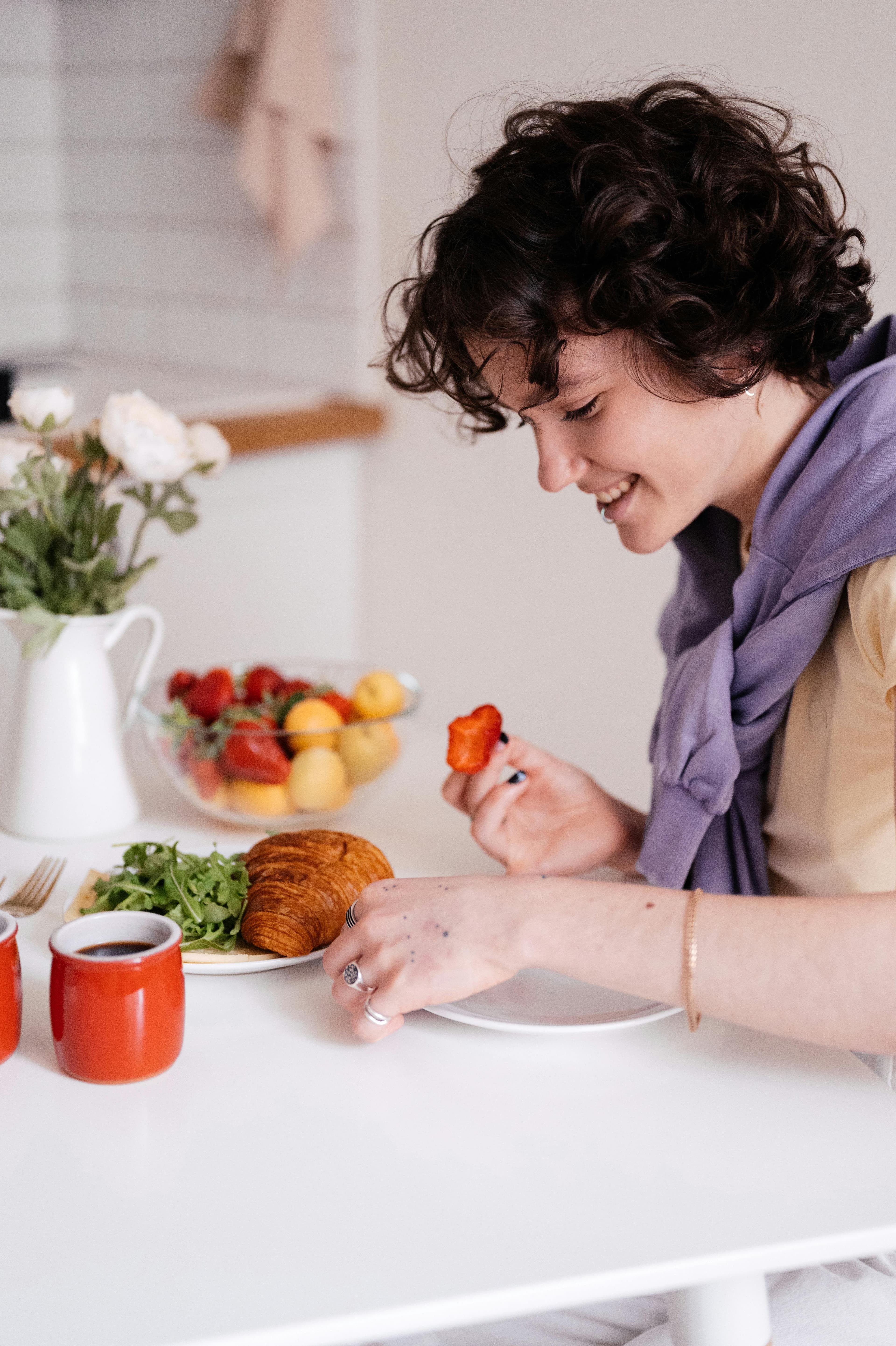 Athlete using a smartphone while preparing breakfast and fruit