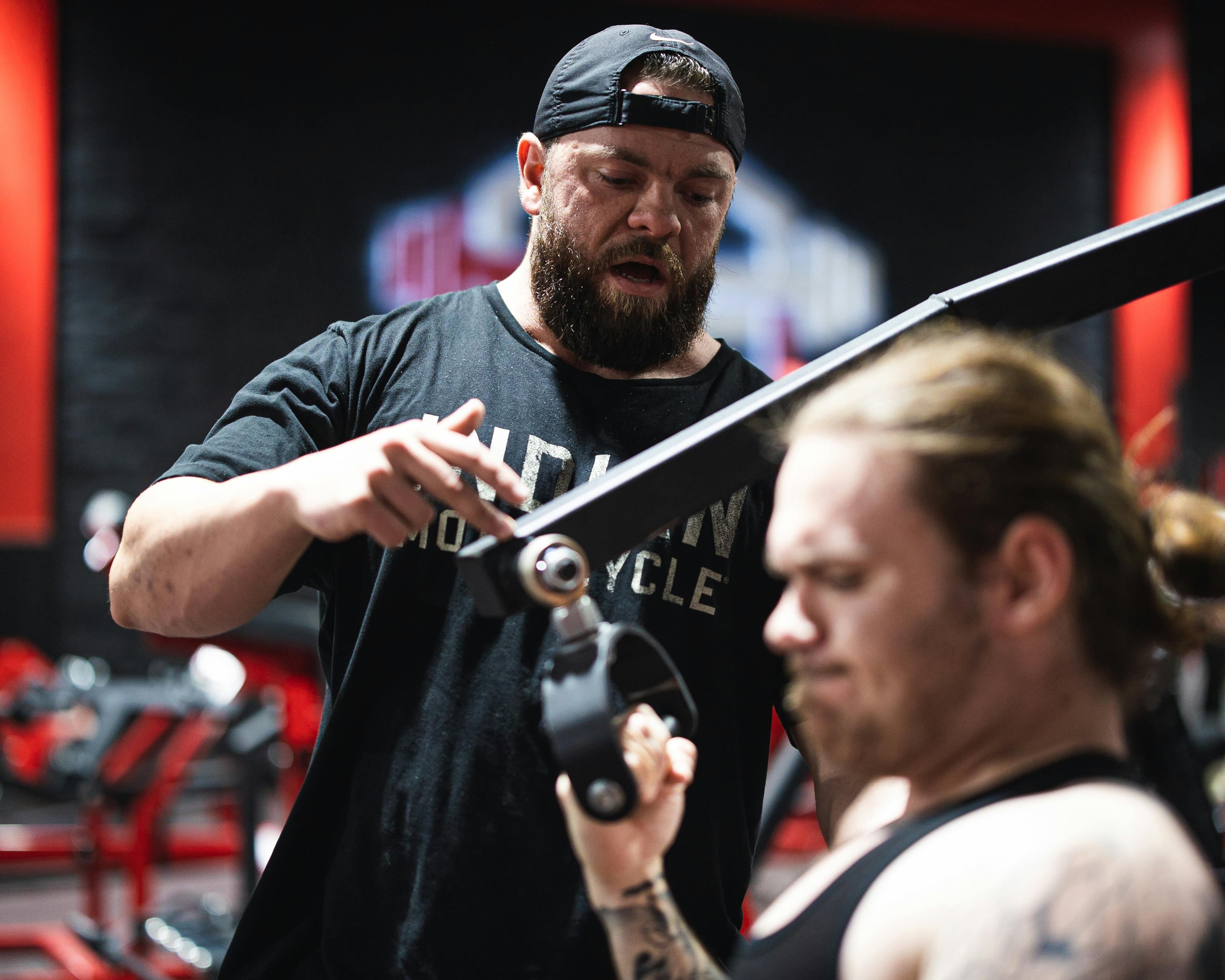 Coach and athlete reviewing a strength training session in the gym