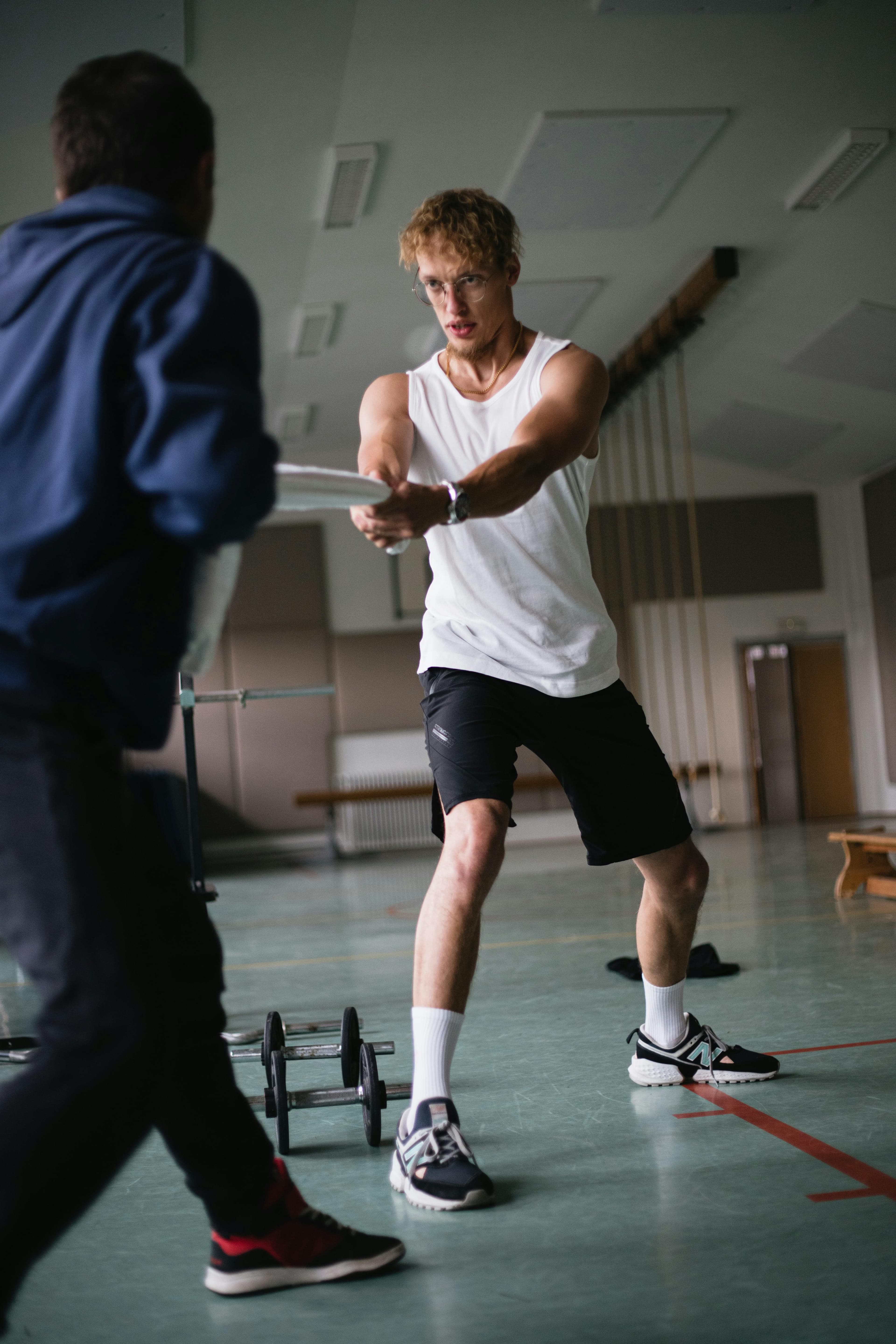 Athlete and trainer reviewing progress after a gym session