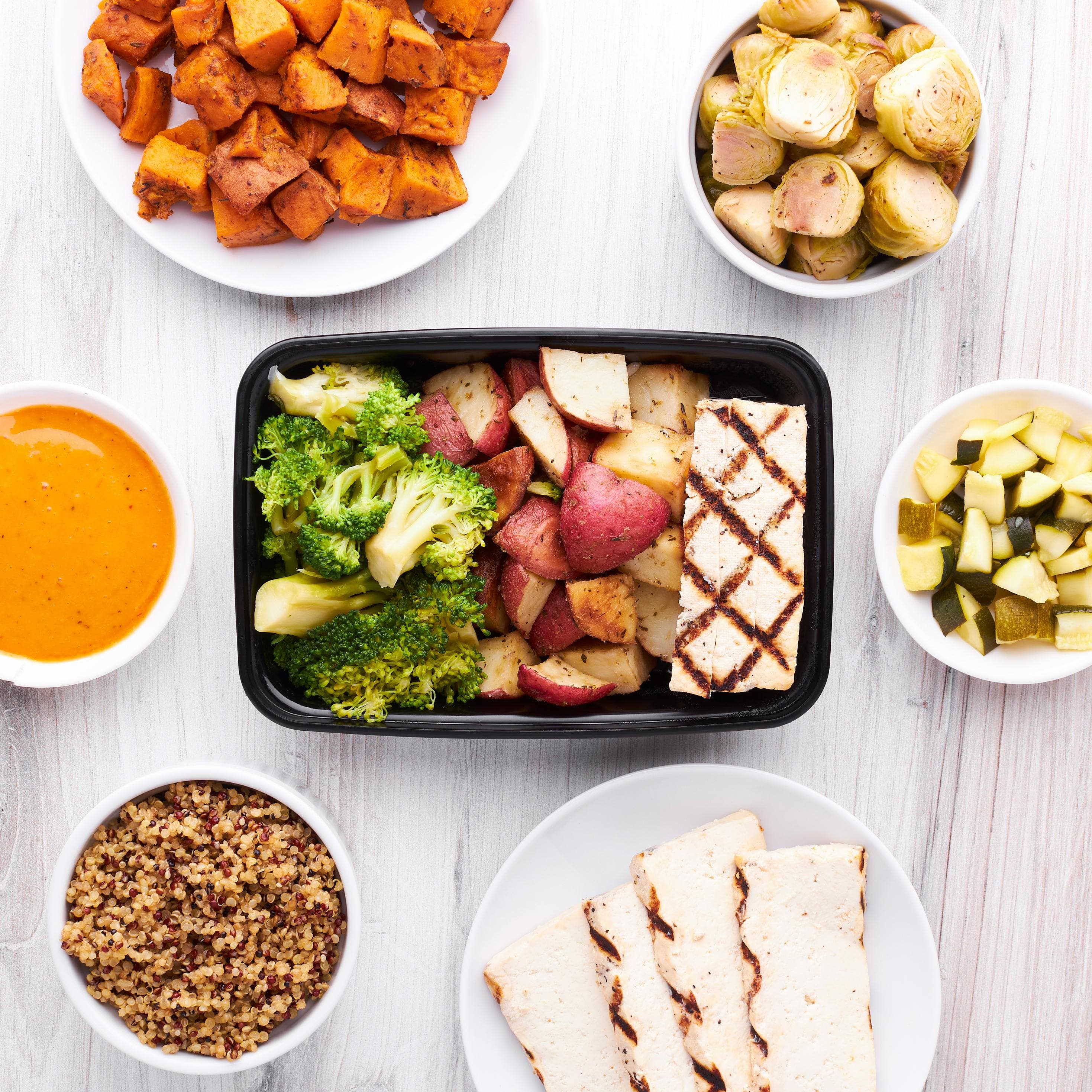 Organized meal prep with protein, carbs, and vegetables for training energy