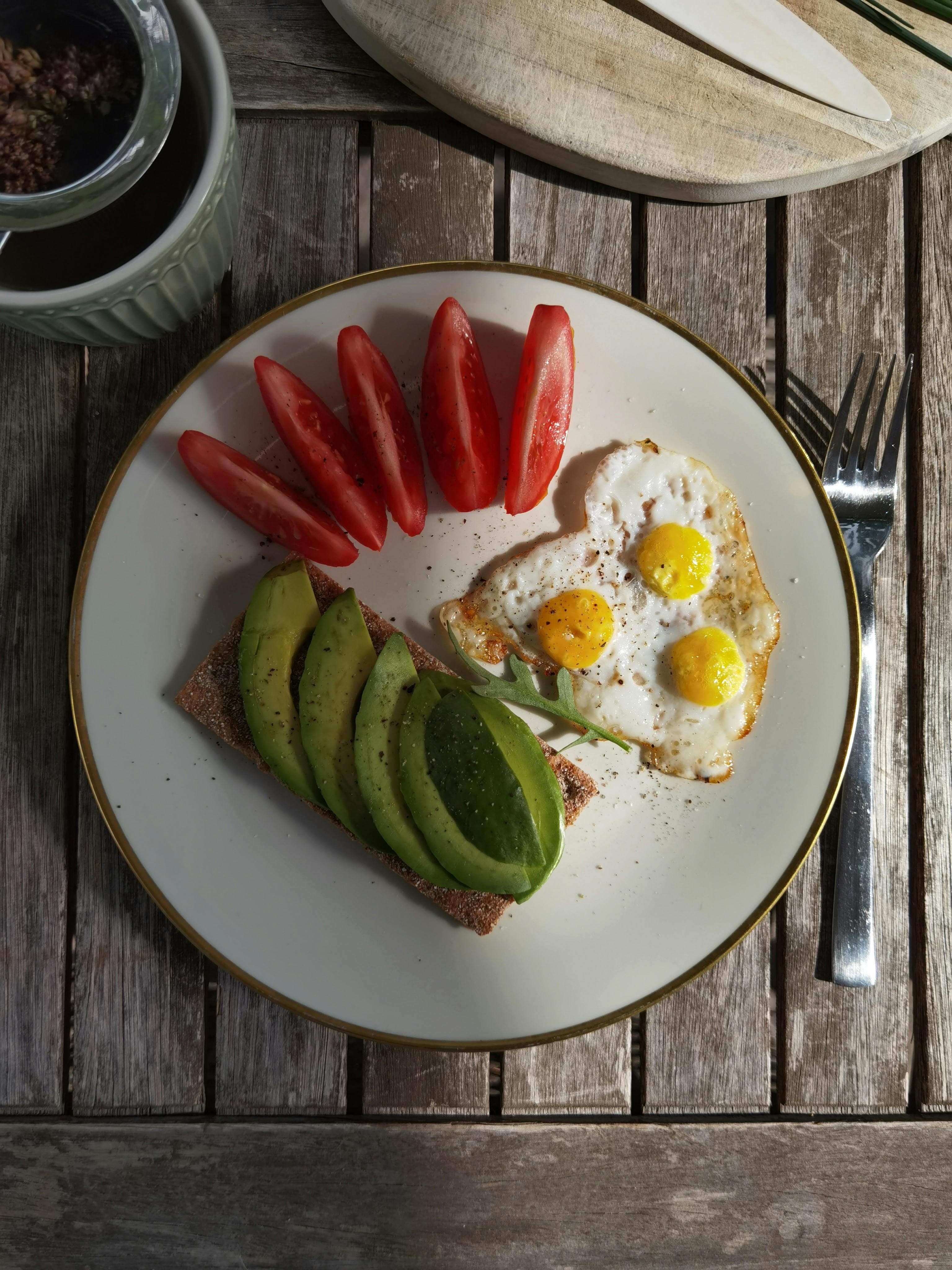 Avocado and eggs breakfast plate representing healthy dietary fats
